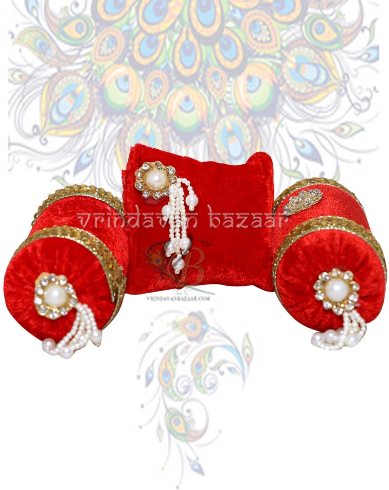 Red velvet decorated cushion with a pair of round pillows