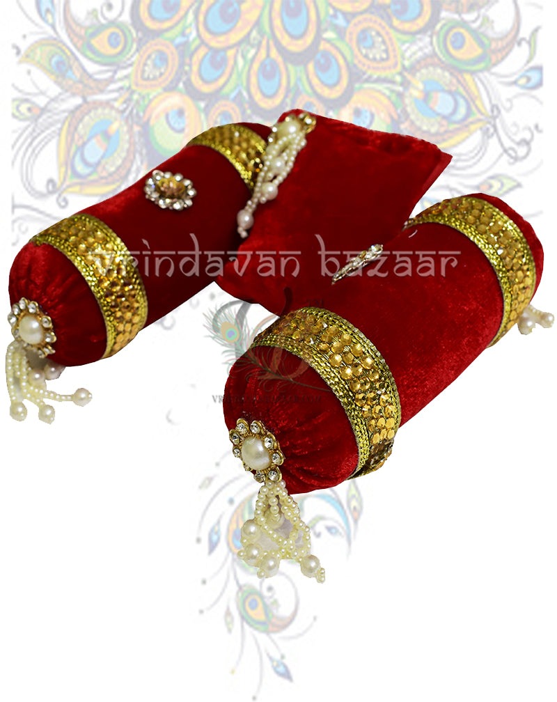Red velvet decorated cushion with a pair of round pillows