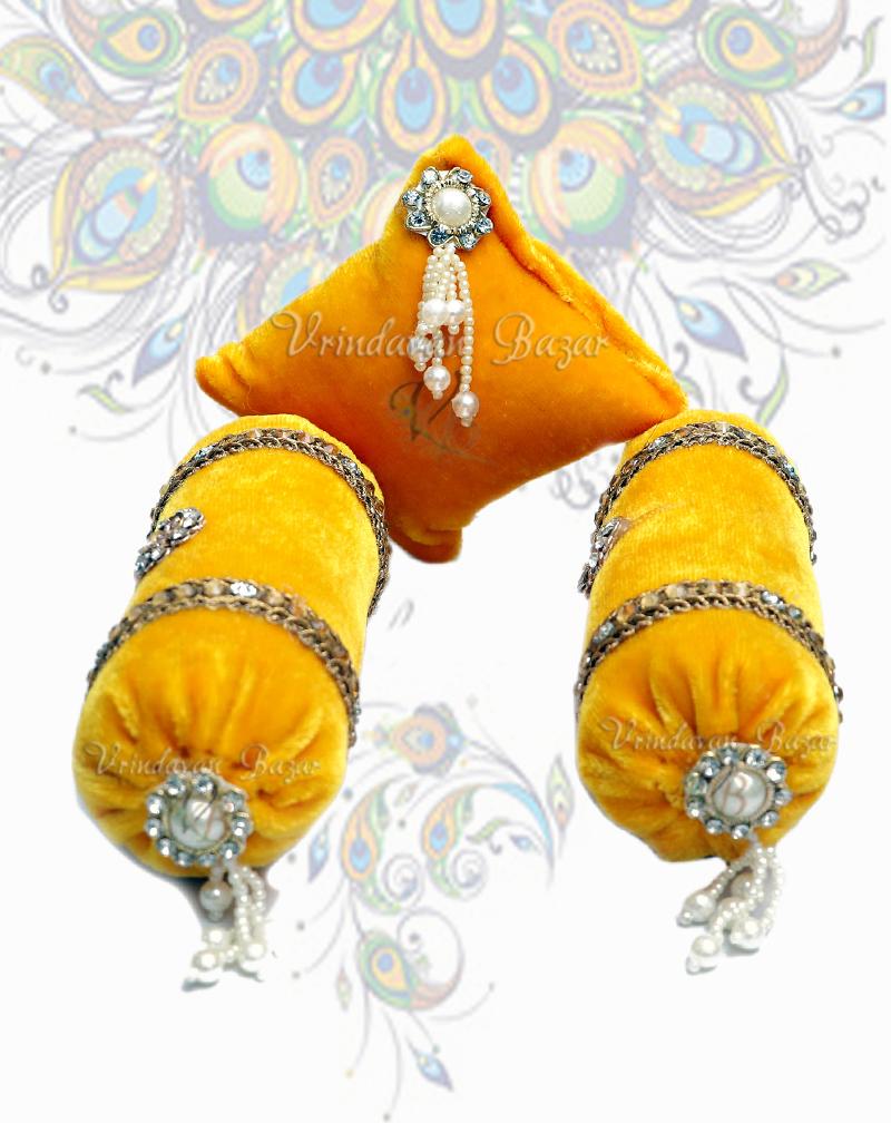 Yellow velvet decorated cushion with a pair of round pillows